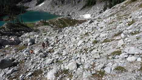 Hikers-and-their-dog-exploring-the-backcountry-with-watersprite-lake-in-the-background