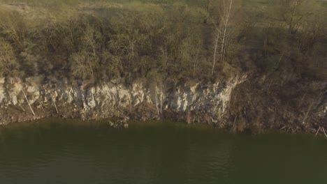 Trees-Without-Leaves-On-The-Edge-Of-A-Quarry-Cliff