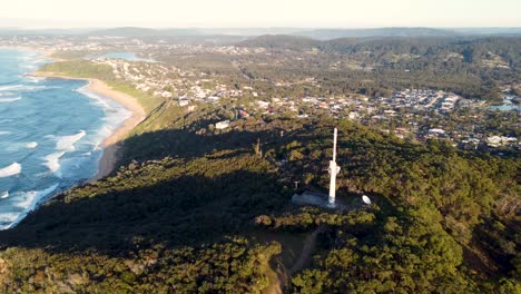 Drone-aerial-shot-of-nature-headland-coastline-Forresters-Beach-TV-tower-Central-Coast-NSW-Australia-4K