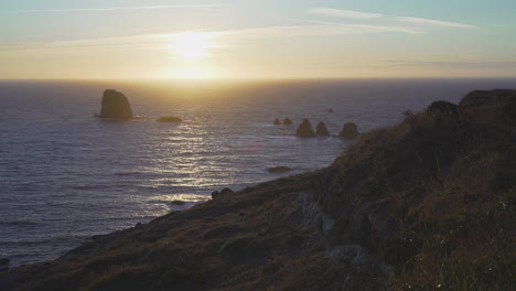 Wide-angle-sunset-over-pacific-ocean,-Blacklock-Point-Oregon-coast