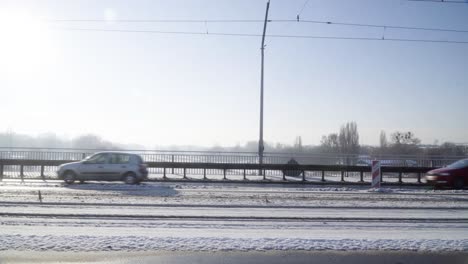 Cars-and-tram-run-on-the-bridge-during-winter-static-shot