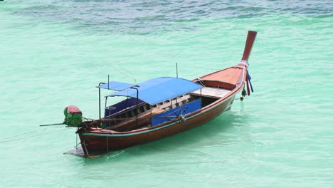 Long-tail-boat-floating-in-sea-near-the-beach
