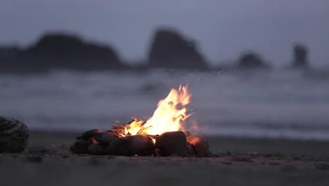 Campfire-burning-on-beach-in-Oregon