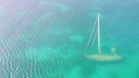 Drone-moving-sideways-to-reveal-a-sunken-sailboat