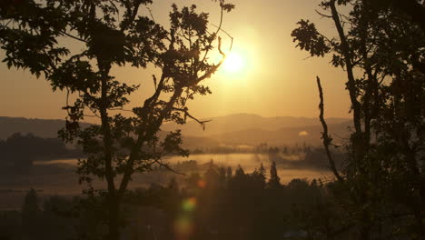 Camera-pan-of-sunrise-over-misty-farm-valley