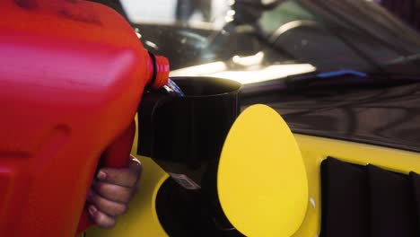 Pouring-fuel-from-the-canister-into-the-yellow-german-super-sport-car