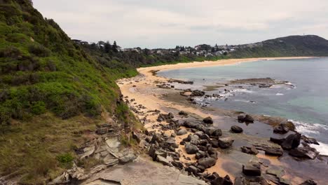 Drone-aerial-shot-of-headland-Forresters-Beach-Spoon-Bay-coastline-sand-rocks-and-beach-Central-Coast-NSW-Australia-4K