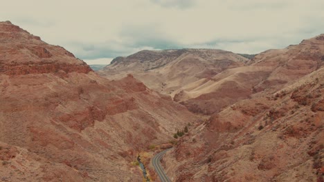 4k-Aerial-red-canyon-with-country-road-in-the-middle-Drone-wild-shot