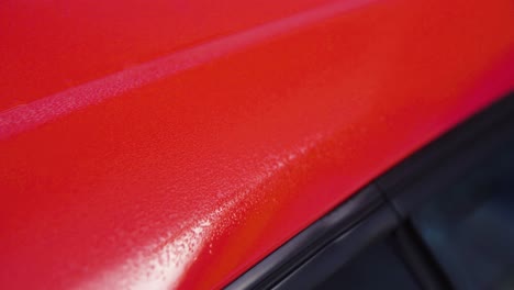 Red-car-with-wet-paint-job-detail-shot-in-slow-motion