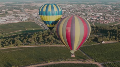 4k-Aerial-Hot-air-balloons-very-close-to-each-other-above-vineyards