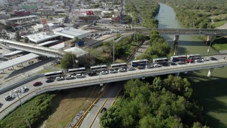 AERIAL---International-Bridge-over-Rio-Grande,-United-States-Mexico-border,-circle-shot