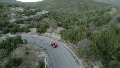 AERIAL---Car-driving-down-the-many-curves-in-a-road,-Tamaulipas,-Mexico,-tracking