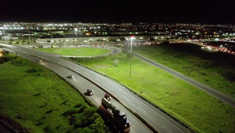 AERIAL---Light-traffic-on-the-highway-at-night-in-Reynosa,-Mexico,-truck-right