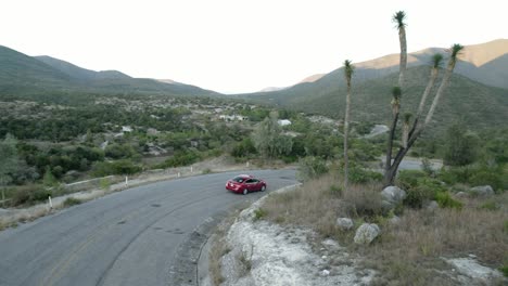 AERIAL---Car-starts-a-road-trip-in-the-Sierra-Madre-mountains,-Tamaulipas,-Mexico