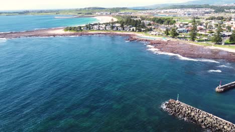 Drone-aerial-shot-of-Shellharbour-crystal-clear-suburb-boat-ramp-Pacific-Ocean-Kiama-South-Coast-tourism-NSW-Australia-4K