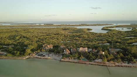 AERIAL---Resort-on-a-beautiful-beach,-Holbox-Island,-Yucatan,-Mexico,-circle-pan