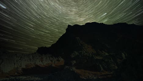 Mesmerizing-timelapse-of-the-star-trails-and-northern-lights-in-the-dark-night-sky-above-the-mountains