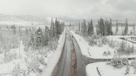 4k-Aerial-snowy-road-in-winter-with-traffic-Drone-dolly-out-shot