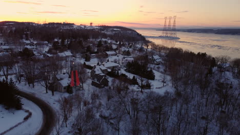 Aerial---Flying-over-houses-on-the-coast-of-the-St-Lawrence-river-at-sunset-1