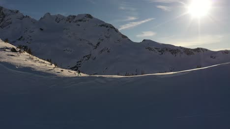 Skier-on-the-mountain-ridge-with-a-cute-husky