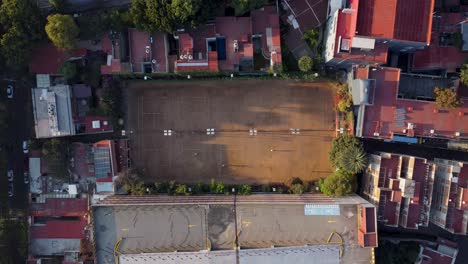 Top-Down-Shot-of-Five-Clay-Tennis-Courts-and-the-Surroundings-in-the-Morning-in-Mexico-City