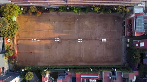 Top-Down-Shot-Flying-Away-from-a-Beautiful-Tennis-Sports-Club-in-the-Morning-in-Mexico-City