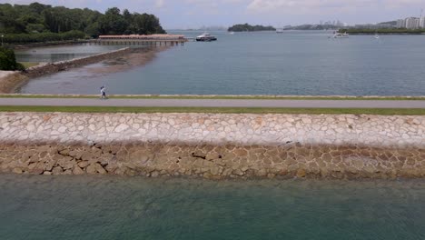 Malerische-Brücke-Mit-Menschen,-Die-Inmitten-Eines-Ruhigen-Ozeans-In-Der-Nähe-Der-Insel-Saint-John-In-Singapur-überqueren