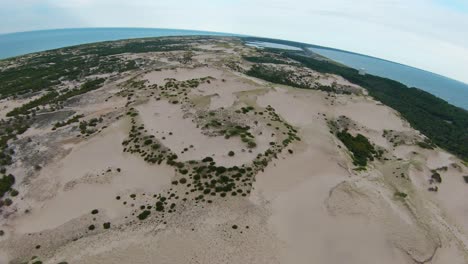 Panoramic-top-down-view-of-the-white-soft-sand-dunes,-and-trails-leading-to-the-Atlantic-Ocean
