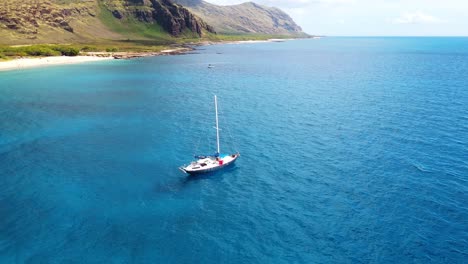 Scenic-view-of-a-small-boat-sailing-in-open-pacific-waters-near-the-Kailua-Beach-Park-with-turquoise-waters-in-Oahu-Hawaii-USA