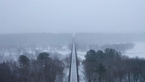 Spectacular-symmetrical,-aerial-view-of-the-Arcola-High-Bridge-during-heavy-snowfall