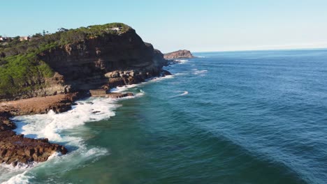Aerial-drone-scenic-shot-of-North-Avoca-waves-headland-and-coastline-nature-Central-Coast-Terrigal-NSW-Australia-4K