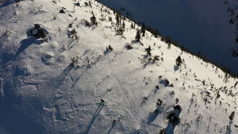 Aerial-view-of-a-skier-climbing-up-the-mountain