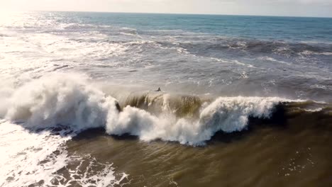 Aerial-drone-landscape-shot-of-bodyboarder-duck-dive-stormwater-wave-foam-swell-Newcastle-NSW-Australia-4K