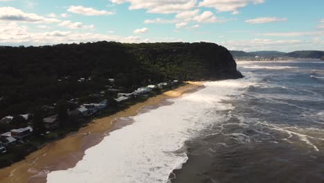 Drone-aerial-shot-of-housing-along-sandy-beach-in-Pearl-Beach-rural-town-Umina-Point-Hawkesbury-River-Central-Coast-tourism-NSW-Australia-4K