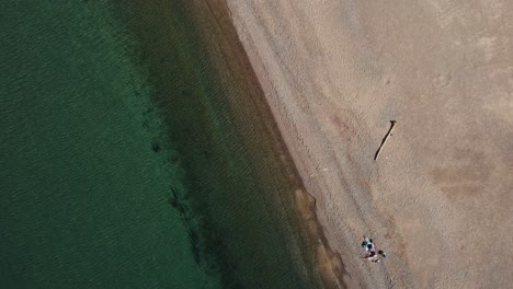Drone-Top-down-view-of-the-people-at-the-sea-coast-in-Llançà,-a-little-town-in-Empordà,-Catalonia,-Spain