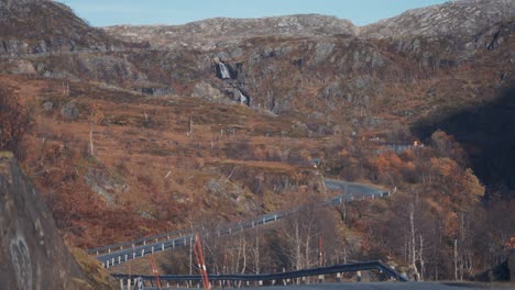 A-narrow-asphalt-road-goes-through-the-autumn-valley-in-the-Norwegian-tundra