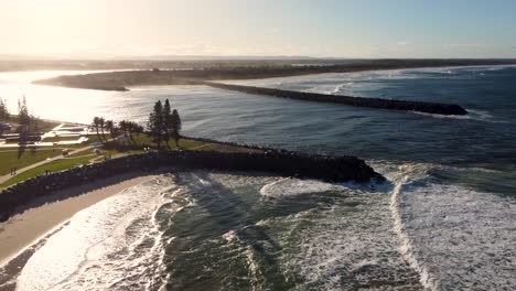 Drone-aerial-shot-of-late-afternoon-sunset-Hastings-river-break-wall-inlet-with-Pacific-Ocean-beaches-waves-travel-tourism-Port-Macquarie-NSW-Mid-north-Coast-Australia-4K