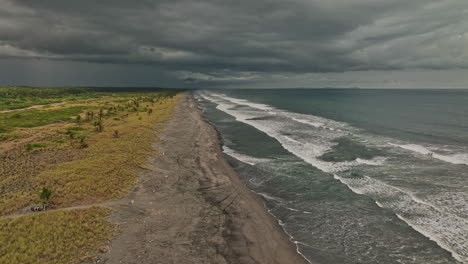 Palo-Grande-Panama-Aerial-v1-severe-weather-approaching,-drone-flyover-beach-of-pacific-coast-capturing-rapid-wave-hitting-the-shore-with-ominous-stormy-sky---Shot-with-Mavic-3-Cine---April-2022