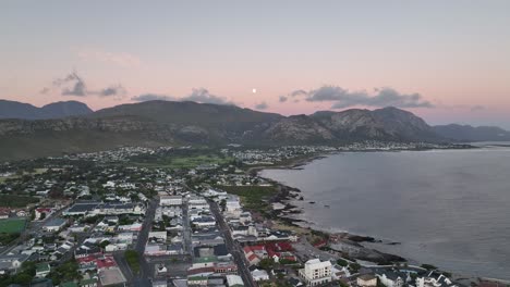 Town-of-Hermanus-in-South-Africa,-drone-flight-after-sunset