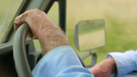 Close-Up-Callous-Hands-Of-Farmer-On-Steering-Wheel-Driving-In-Rural-Australian-Road,-4K