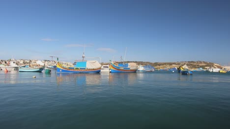 The-Colourful-Traditional-Maltese-Fishing-Boats,-The-Luzzu-and-the Kajjik-at-Marsaxlokk,-Malta