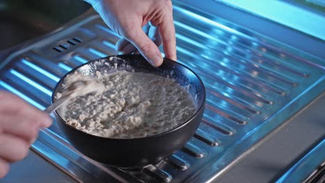 Stirring-Oatmeal-Mixture-In-A-Ceramic-Bowl-Using-Fork