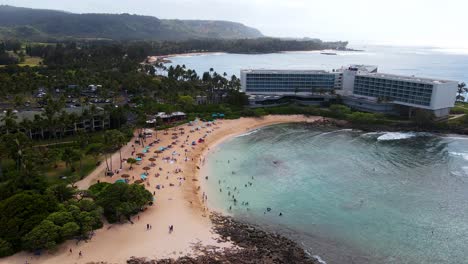 Drone-shot-of-Turtle-Bay-with-people-on-beaches-in-Oahu,-Hawaii