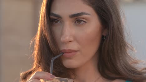 Beautiful-woman-sips-on-an-iced-coffee-in