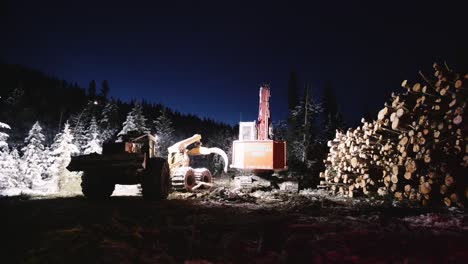 Night-time-industrial-wood-logging-operation-machinery-moving-around