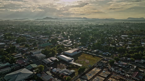 David-Panama-Aerial-v17-sunrise-view,-drone-flyover-el-carmen-and-el-vedado-neighborhoods-capturing-golden-sunlight-shinning-across-residential-townscape---Shot-with-Mavic-3-Cine---April-2022