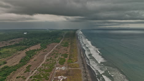 Palo-Grande-Panama-Aerial-v6-panoramic-view-drone-flyover-pacific-coast-capturing-guarumal-agricultural-farmland-with-ominous-dark-clouds-gathering-in-the-sky---Shot-with-Mavic-3-Cine---April-2022