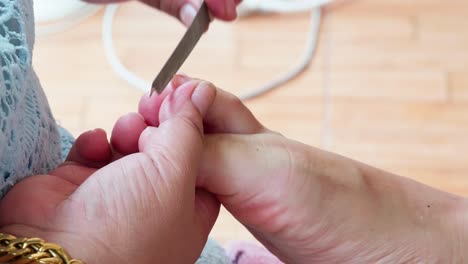 Pedicurist-master-making-pedicure-cutting-cuticle-with-nail
