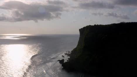 Silhouette-of-majestic-cliffs-standing-tall-beside-coastline