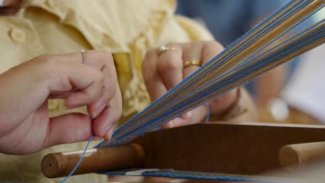 Loom-of-yarn-being-weaved-and-pressed-into